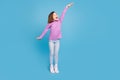 Full length body size little girl smiling showing heigh isolated pastel blue color background Royalty Free Stock Photo