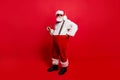 Full length body size of nice calm peaceful Santa pulling suspen