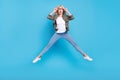 Full length body size photo amazed woman in glasses jumping up amazed isolated pastel blue color background