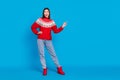 Full length body size photo amazed woman showing copyspace in red sweater isolated bright blue color background