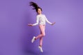Full length body size photo carefree cheerful jumping high funny schoolgirl isolated on vivid violet color background