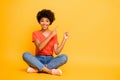 Full length body size photo of cheerful kind positive charming casual wavy trendy youngster sitting on floor wearing