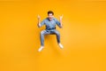 Full length body size photo of cheerufl shouting guy with fingers horned wearing sneakers showing rock horned fingers Royalty Free Stock Photo