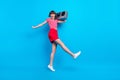 Full length body size photo dancing girl keeping boom box isolated bright blue color background Royalty Free Stock Photo