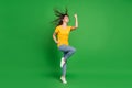 Full length body size photo dreamy girl brunette hair gesturing like winner isolated vivid green color background