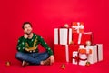 Full length body size photo dreamy man looking copyspace with presents on xmas isolated bright red color background