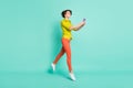 Full length body size photo of female blogger taking selfie usinf smartphone isolated vivid turquoise color background