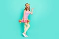 Full length body size photo girl cheerful wearing cap keeping longboard keeping copyspace on hand  vivid teal Royalty Free Stock Photo