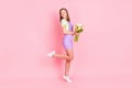 Full length body size photo of girl dreamy looking blank space keeping tulip flowers bouquet isolated pastel pink color