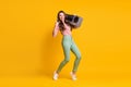 Full length body size photo of girl listening to retro boombox showing horns heavy metal sign isolated on vibrant yellow Royalty Free Stock Photo