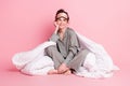 Full length body size photo of girl in pajama sleeping mask sitting dreamy in blanket isolated on pastel pink color