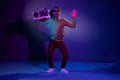 Full length body size photo guy in sunglass keeping tape recorder dancing in night club isolated dark violet color Royalty Free Stock Photo