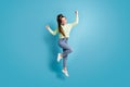 Full length body size photo of jumping girl ponytail gesturing like winner shouting isolated on vibrant blue color