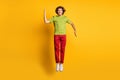 Full length body size photo of jumping man playful smiling pretending robot isolated bright yellow color background
