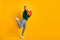 Full length body size photo laughing girl showing heart love symbol isolated on vivid yellow color background with