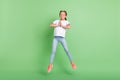 Full length body size photo little girl jumping up asking wish isolated pastel green color background Royalty Free Stock Photo