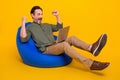 Full length body size photo man gesturing like winner using laptop isolated vivid yellow color background Royalty Free Stock Photo