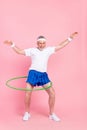 Full length body size photo man keeping hoola hoop training in gym hands over head funny isolated pastel pink color Royalty Free Stock Photo