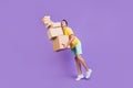 Full length body size photo man walking with falling carton boxes isolated pastel violet color background