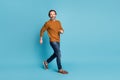 Full length body size photo middle-aged bearded man smiling going fast hurrying in casual outfit isolated on vibrant