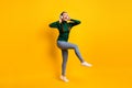 Full length body size photo overjoyed girl listening music singing song dancing party isolated on vibrant yellow color