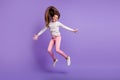 Full length body size photo playful careless laughing jumping throwing long hair isolated on vivid purple color