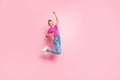 Full length body size photo of trendy cheerful ecstatic girl rejoicing with victory jumping crazily isolated over pastel Royalty Free Stock Photo