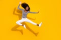 Full length body size photo woman in white pants practicing karate kicking with leg isolated vibrant yellow color
