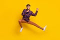 Full length body size photo of young man careless jumping playful fighting on training isolated vibrant yellow color