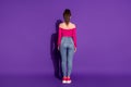 Full length body size rear back behind view of attractive slim fit girl wearing smart casual look isolated bright violet Royalty Free Stock Photo