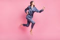 Full length body size side profile photo of girl wearing nightwear jumping running on pajama party isolated on pastel