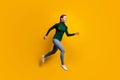 Full length body size side profile photo laughing girl jumping high running fast isolated on vibrant yellow color