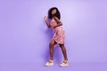 Full length body size side profile photo overjoyed curly girl dancing in dress at party isolated pastel purple color