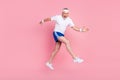 Full length body size side profile photo senior man jumping high running fast smiling isolated pastel pink color Royalty Free Stock Photo