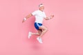 Full length body size side profile photo senior man jumping running looking copyspace isolated pastel pink color Royalty Free Stock Photo