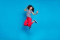 Full length body size turned photo of cheerful positive cute curly wavy pretty girlfriend jumping in striped t-shirt red
