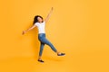 Full length body size turned photo of cheerful pretty crazy dancing girl wearing white t-shirt jeans denim footwear