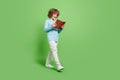 Full length body size view of attractive cheerful amazed guy reading book going isolated over vivid green color