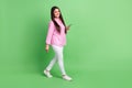 Full length body size view of attractive cheerful girl going using gadget blogging app smm isolated over green pastel