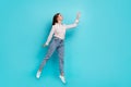 Full length body size view of attractive cheerful girl jump want reach aim hold blank space isolated on bright cyan