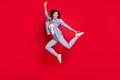 Full length body size view of attractive cheerful girl jumping dancing active motion isolated over bright red color Royalty Free Stock Photo