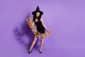 Full length body size view of attractive cheerful girl vamp lady holding festal decor isolated over violet purple color Royalty Free Stock Photo