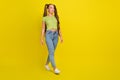 Full length body size view of attractive cheerful long-haired girl walking isolated over bright yellow color background Royalty Free Stock Photo
