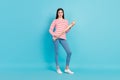 Full length body size view of attractive confident powerful girl holding basketball bat isolated over bright blue color