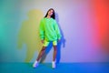 Full length body size view of attractive cool girl wearing sporty clothes posing isolated over multicolor vivid neon