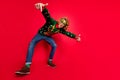 Full length body size view of attractive funky cool guy dancing fooling isolated over bright red color background