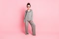 Full length body size view of attractive moody sullen girl wearing pajama bad mood isolated over pink pastel color