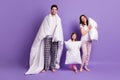 Full length body size view of cheerful careful family mom dad small little daughter wearing sleepwear carrying pillow Royalty Free Stock Photo