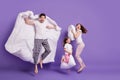 Full length body size view of cheerful cheery glad funny family small little daughter jumping pillow duvet having fun Royalty Free Stock Photo