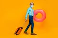 Full length body size view of grandparent gentleman carrying life rubber circle buoy departure resort wearing safe mask